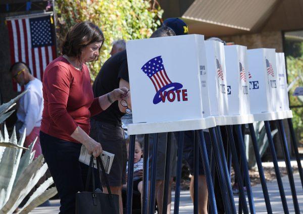 People vote at outdoor booths during early voting for the mid-term elections in Pasadena, Calif., on Nov. 3, 2018. (Mark Ralston/AFP/Getty Images)