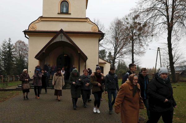 Parishioners leave the church after the mass in Kalinowka, Poland, on Nov. 25, 2018. (Reuters/Kacper Pempel)