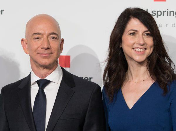 Amazon CEO Jeff Bezos and his wife MacKenzie Bezos pose as they arrive at the headquarters of publisher Axel-Springer in Berlin on April 24, 2018. (Jorg Carstensen/AFP/Getty Images)