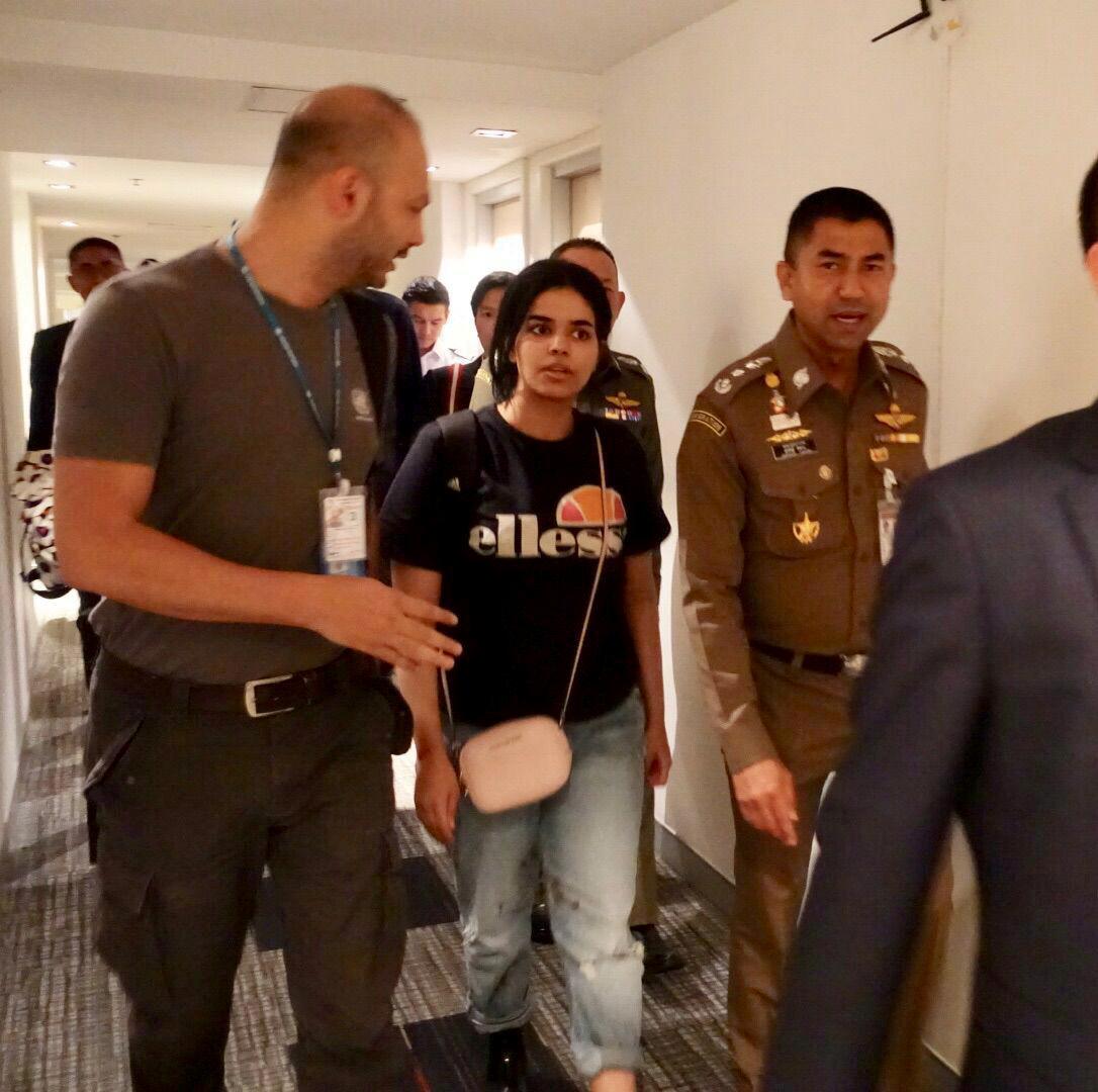 Saudi teen Rahaf Mohammed Alqunun walks with Thai immigration authorities at a hotel inside Suvarnabhumi Airport in Bangkok, Thailand, on Jan. 7, 2019. (Thailand Immigration Police via Reuters)