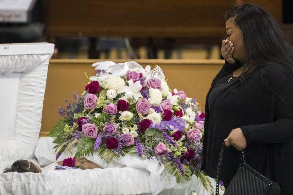 A mourner approaches the casket of Jazmine Barnes during a viewing ceremony before the memorial services, on Jan. 8, 2019 at the Community of Faith Church in Houston. (Marie De Jesus/Houston Chronicle/AP)