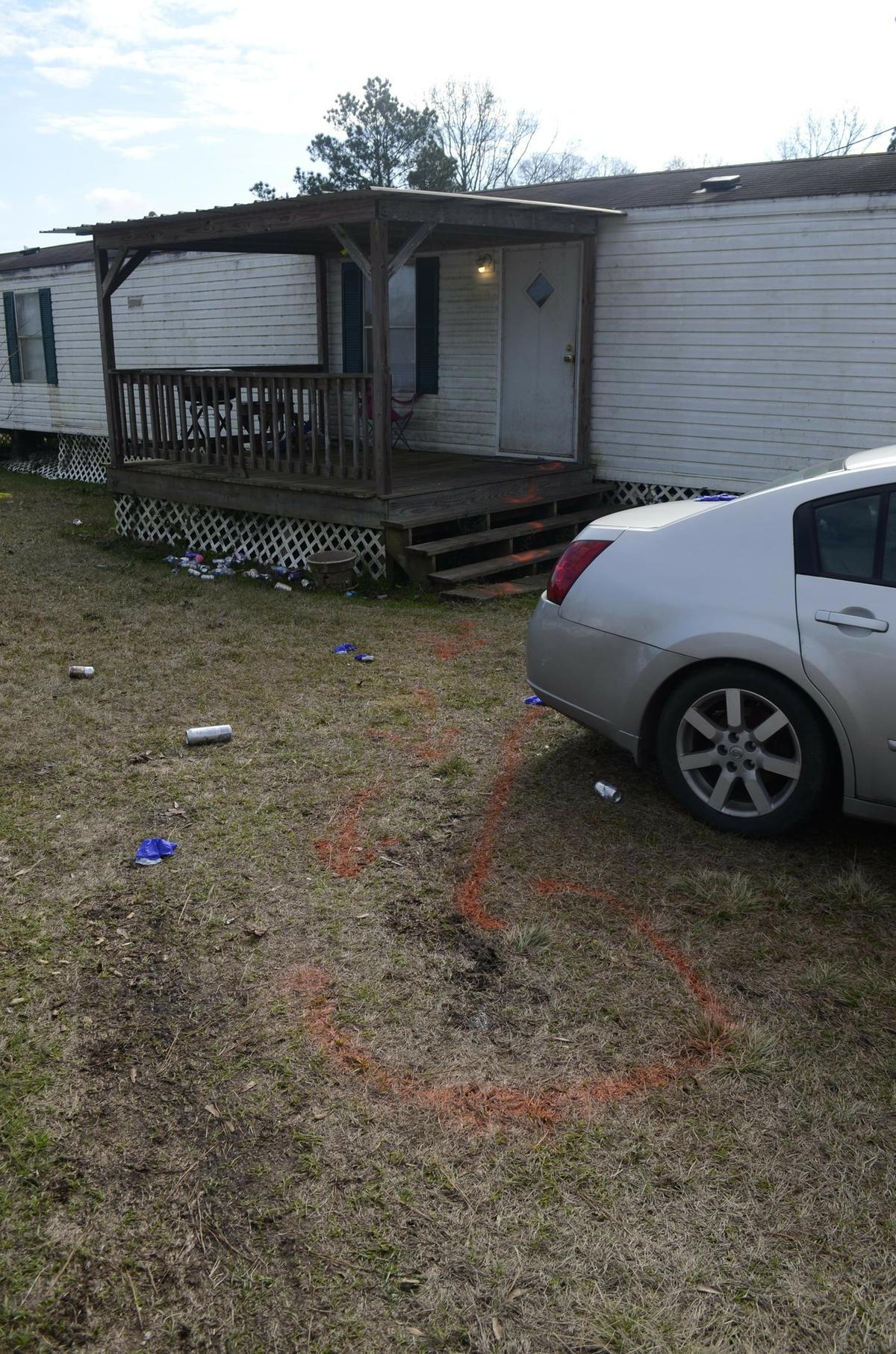 Orange spray paint, left by investigators, marks the steps from the front door of Ericka Hall's home in Magnolia, Miss., to a spot in her yard where she collapsed on Jan. 5, 2018. (Matt Williamson/The Enterprise-Journal via AP)