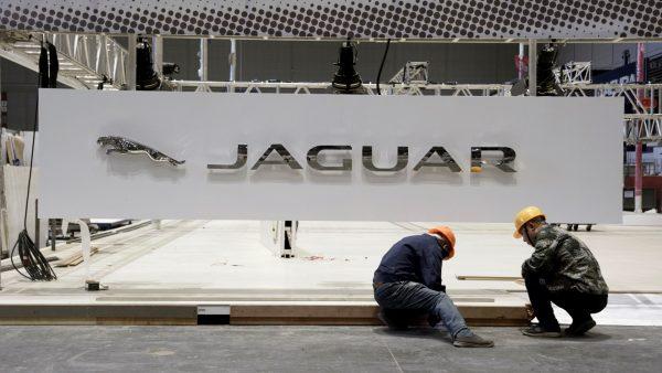 Workers set up the booth for British car manufacturer Jaguar Land Rover's Jaguar brand inside the National Exhibition and Convention Center, the venue for the upcoming China International Import Expo (CIIE), in Shanghai, China, on Oct. 28, 2018. (China Daily/Reuters)