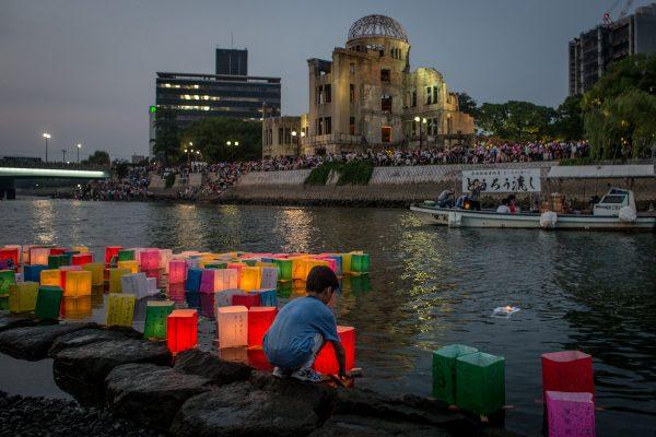 A boy floats a candle-lit paper lantern on the river in front of the Atomic Bomb Dome during 70th-anniversary activities, commemorating the atomic bombing of Hiroshima at the city's Peace Memorial Park on August 6, 201 5, in Japan. The bomb instantly killed an estimated 70,000 people and thousands more in coming years from radiation effects. Three days later, the United States dropped a second atomic bomb on Nagasaki, which ended World War II. (Chris McGrath/Getty Images)