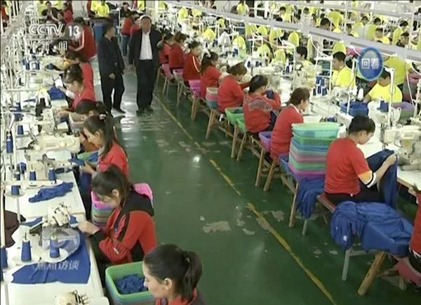 Muslim trainees work in a garment factory at the Hotan Vocational Education and Training Center in Hotan, Xinjiang, China. (CCTV via AP Video)