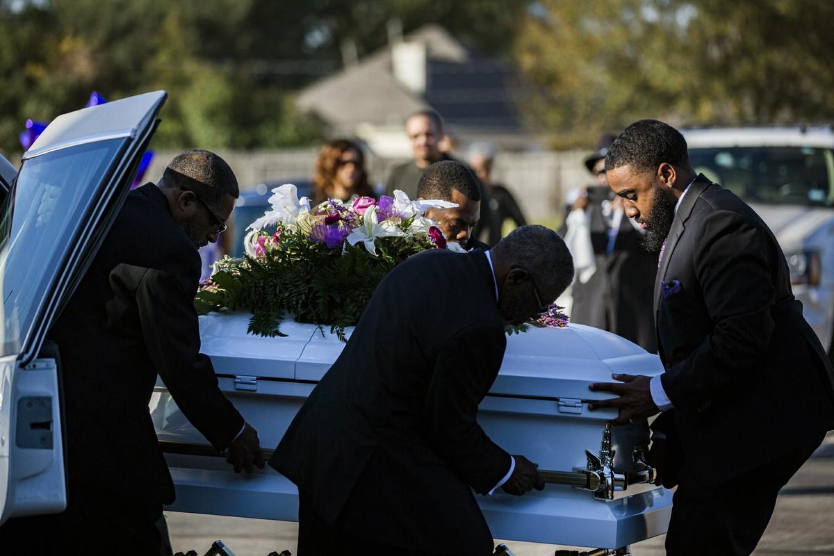 The casket of Jazmine Barnes is removed from the funeral hearse to be taken inside the Community of Faith Church for a memorial service, Tuesday, Jan. 8, 2019, in Houston. (Marie De Jesus/Houston Chronicle/AP)
