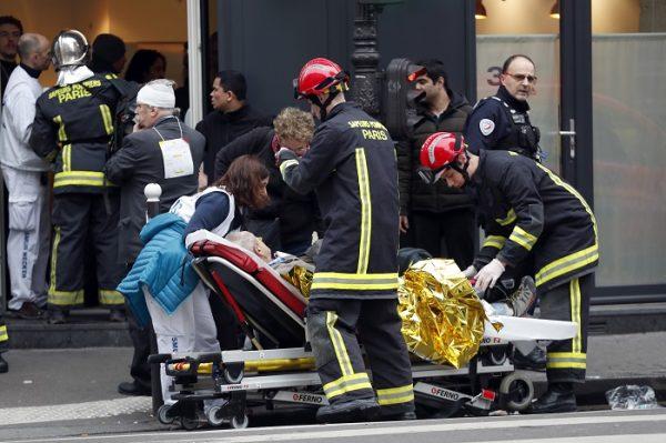 Medical staff and firefighters tend to a wounded man at the scene of a gas leak explosion in Paris, France, on Jan. 12, 2019. (AP Photo/Thibault Camus)