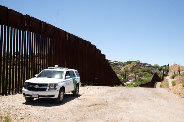 A Border Patrol truck sits next to the fence at the U.S.–Mexico border in Nogales, Ariz., on May 23, 2018. (Samira Bouaou/The Epoch Times)