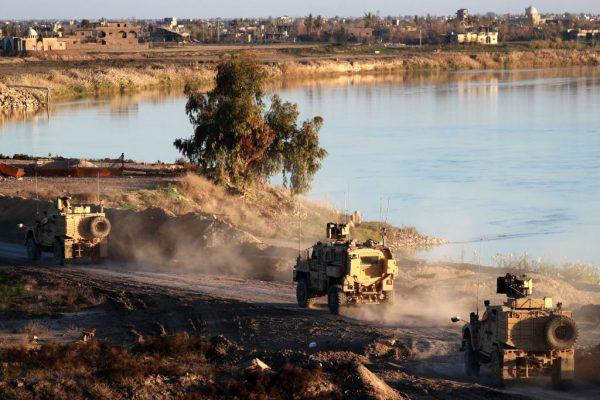 This picture shows US army vehicles supporting the Syrian Democratic Forces (SDF) in Hajin, in the Deir Ezzor province, eastern Syria, on Dec.15, 2018. (Delil Souleiman/AFP/Getty Images)