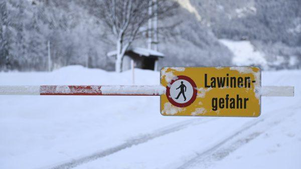 A danger sign " danger of avalanches" displayed at a closed street. (Kerstin Joensson/AP)
