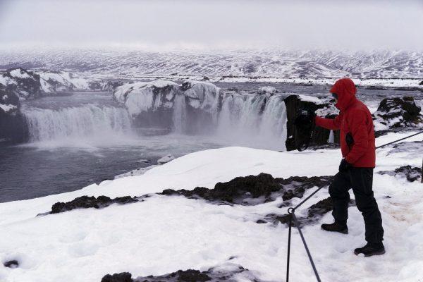 A tourist from Singapore photographs the Godafoss waterfall, a landmark view in northern Iceland, on Dec. 16, 2018. (Egill Bjarnason/AP)