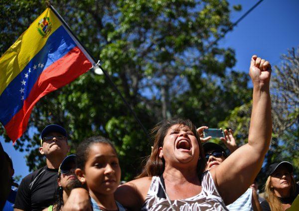 A woman shouts slogans as opposition supporters wait for the arrival of National Assembly President Juan Guaido for an open meeting in Vargas, Venezuela, on Jan. 13, 2019. (Yuri Cortez/AFP/Getty Images)
