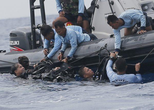 Indonesian navy frogmen emerge from the water during a search operation for the victims of the crashed Lion Air plane in the waters of Tanjung Karawang, Indonesia, on Oct. 30, 2018. (Tatan Syuflana/AP)