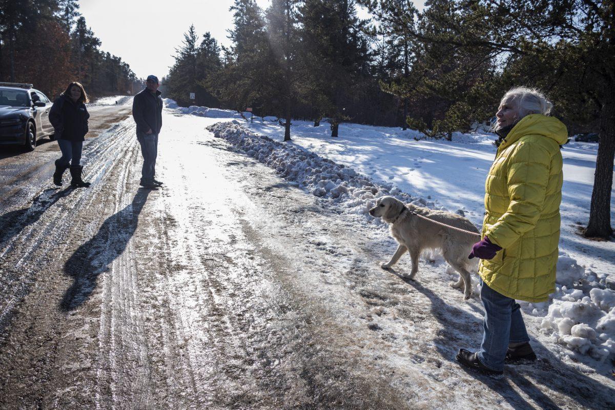 (L-R) Kristin Kasinskas, husband, Peter, and Jeanne Nutter and her dog Henry head back to their homes after speaking with the media in Gordon, Wis., on Jan. 11, 2019. (Richard Tsong-Taatarii/Star Tribune via AP)