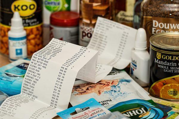 A long paper receipt is pictured next to various products. (Pixabay)