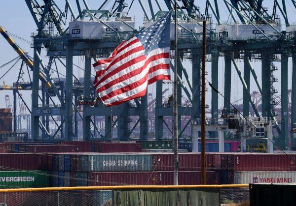 The U.S. flag flies over Chinese shipping containers that were unloaded at the Port of Long Beach, in Los Angeles County, on Sept. 29, 2018. (Mark Ralston/AFP/Getty Images)