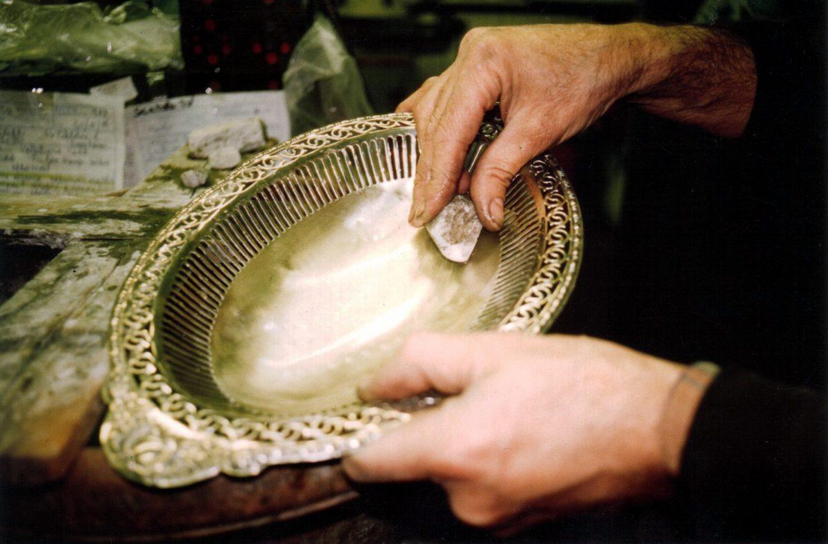 A pumice stone is used to remove abrasions to the silver during restoration. (Lorenzo Michelini/Argentiere Pagliai)