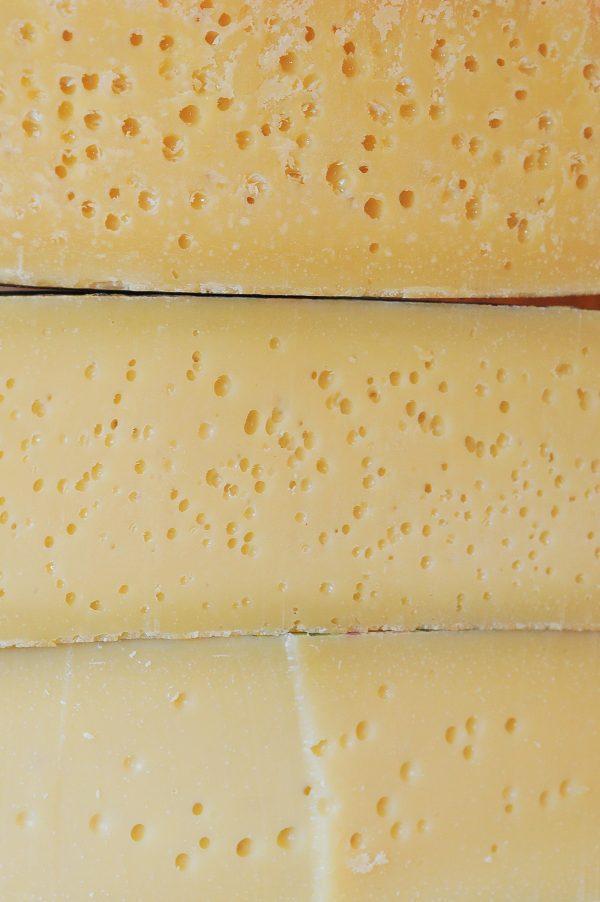 Three wheels of Asiago Stagionato at different ages. As the cheese matures, its texture hardens and its flavor becomes more pronounced. (Roberto Costa Ebech)