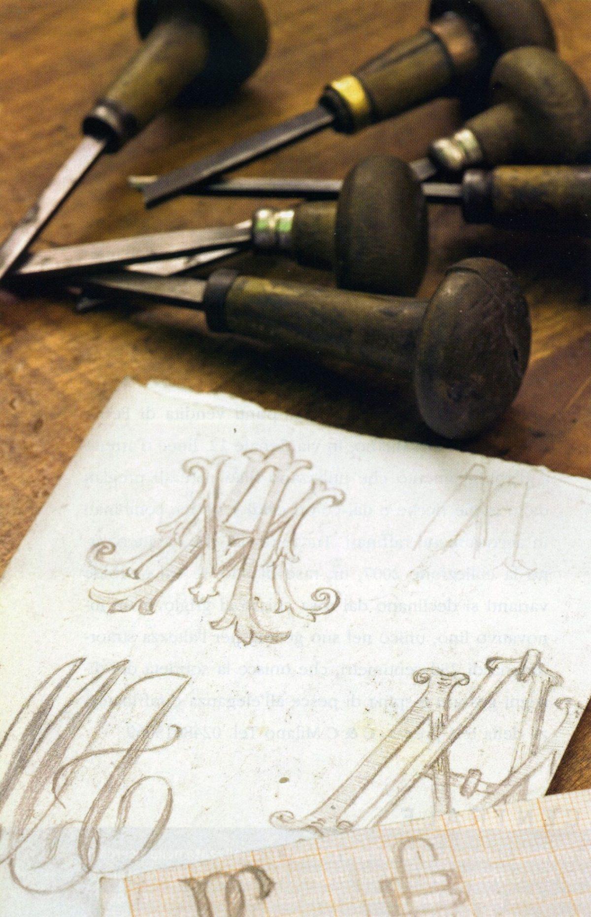 Monogram designs alongside tools for hand engraving. (Lorenzo Michelini/Argentiere Pagliai)