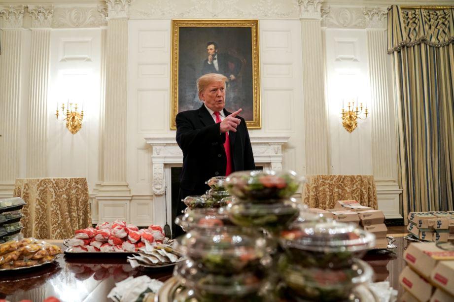 President Donald Trump speaks in front of fast food provided for the 2018 College Football Playoff National Champion Clemson Tigers due to the partial government shutdown in the State Dining Room of the White House in Washington on Jan. 14, 2019. (Joshua Roberts/Reuters)