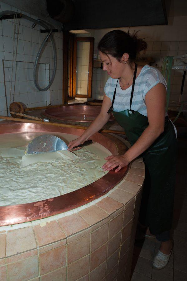 Twenty-three-year-old Sara Strazzabosco prepares Asiago in a copper vat at Malga Larici di Sotto, run by her family for 22 years. (Roberto Costa Ebech)