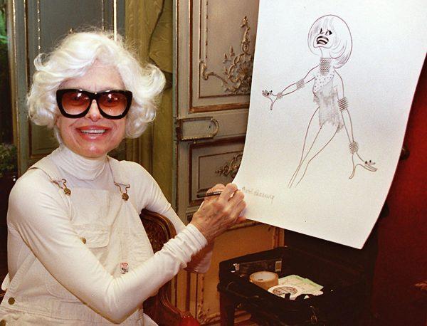 Actress Carol Channing hand-signs a lithograph of herself by caricaturist Al Hirschfeld at her home in Beverly Hills, Calif. Channing, whose career spanned decades on Broadway and on television has died at age 97. (Damian Dovarganes/AP Photo, File)