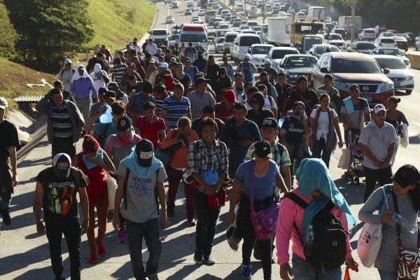 Migrants traveling in a group begin their journey toward the U.S. border as they walk along a highway in San Salvador, El Salvador, early Wednesday, Jan. 16, 2019. (AP Photo/Salvador Melendez)