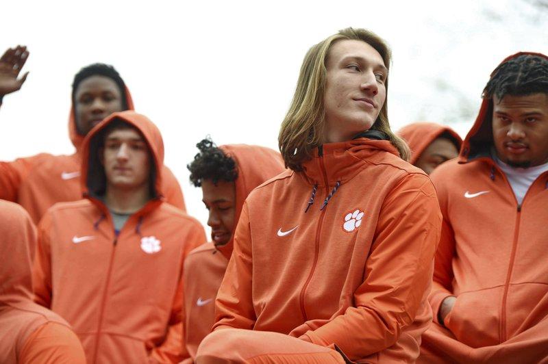 Clemson quarterback Trevor Lawrence, foreground, and fellow freshmen ride in the parade honoring the football team, in Clemson, S.C., after the Tigers defeated Alabama 44-16 in the NCAA College Football Playoff championship on Jan. 12, 2019. (Richard Shiro/AP Photo, File)