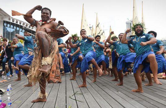 Men from the pacific island nations of Tonga and Fiji perform a traditional Haka after arriving in Sydney, Australia, on Nov. 12, 2014. (Peter Parks/AFP/Getty Images)