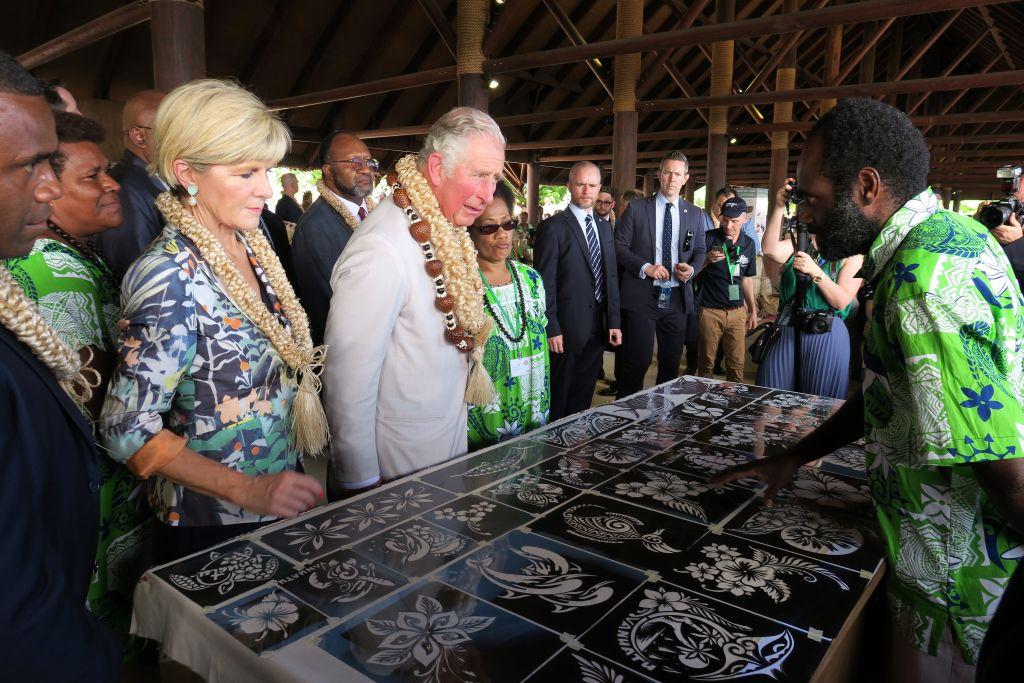 Britain's Prince Charles (C) speaks to a local artist as he and and Australia's Foreign Minister Julie Bishop (front L) visit a market house in Port Vila on April 7, 2018. (Ben Bohane/AFP/Getty Images)