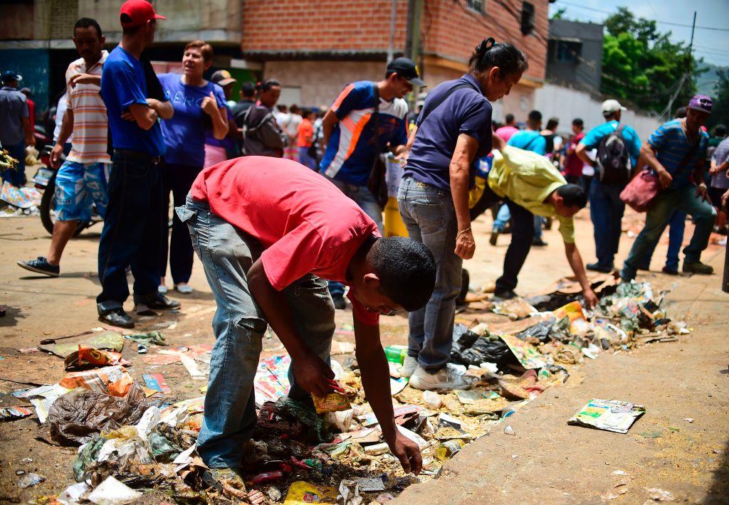 People look for food outside a looted supermarket at El Valle neighborhood, in Caracas, on April 21, 2017, after demonstrations against the government of Venezuelan President Nicolas Maduro. Venezuela was rocked overnight by fresh violence in anti-government protests that have now claimed nine lives in three weeks, as an official reported Friday the fatal shooting of another man. (Ronaldo Schemidt/AFP/Getty Images)