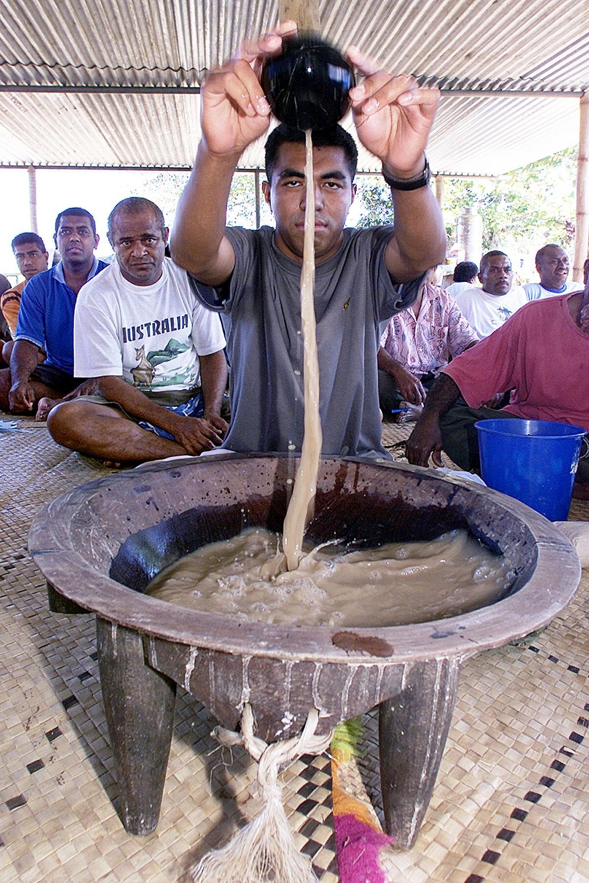 Jone Levaci (C) of coup leader George Speight's SVT Party mixes laqona beverage, also known as kava, for the party's faithful at a polling booth in Suva, 31 August 2001. (Torsten Blackwood/AFP/Getty Images)