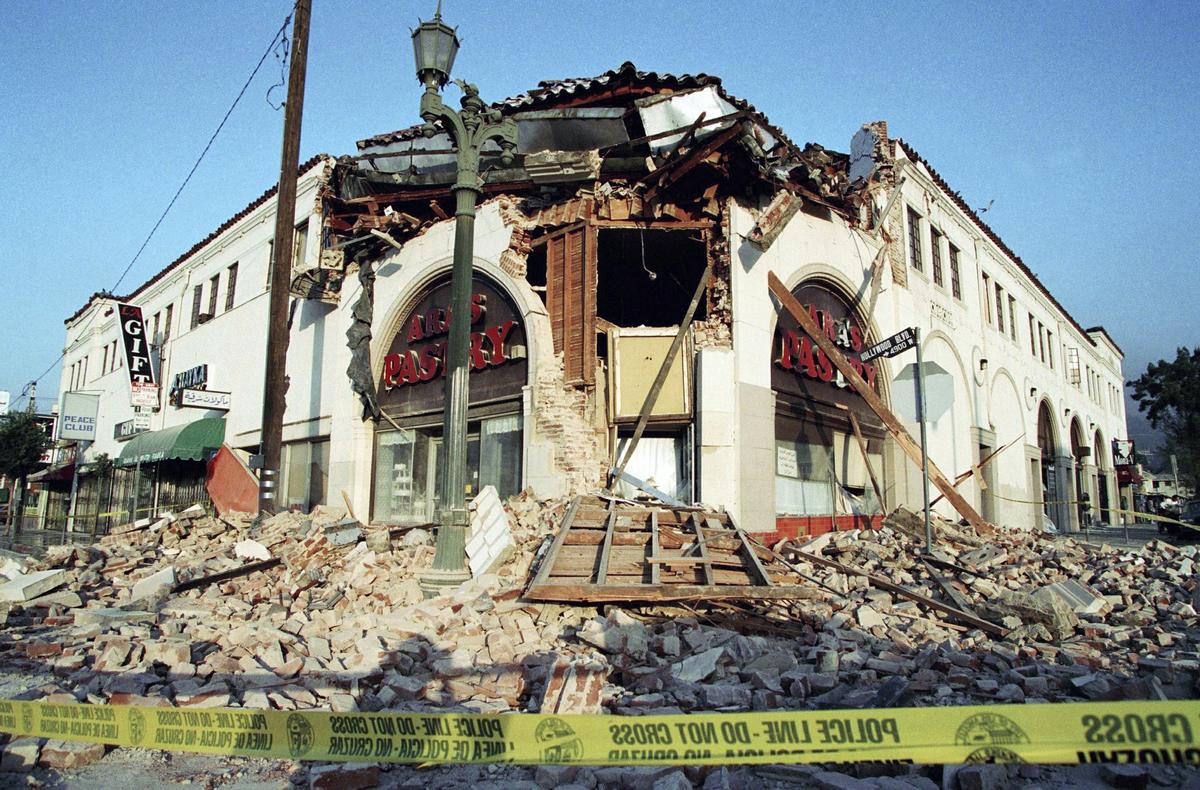 This Jan. 17, 1994 file photo shows bricks and debris surrounding a building housing Ara's Pastry on Hollywood Boulevard in the Hollywood section of Los Angeles, following the Northridge earthquake. (AP Photo/Rene Macura)