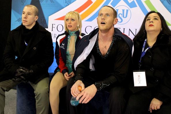 COLORADO SPRINGS, CO - FEBRUARY 12: Flanked by their coaches Larry Ibarra and Dalilah Sappenfield, Caydee Denney and John Coughlin watch their routine in the Kiss & Cry after the Pairs Free Skate during the ISU Four Continents Figure Skating Championships at World Arena on February 12, 2012 in Colorado Springs, Colorado. (Matthew Stockman/Getty Images)