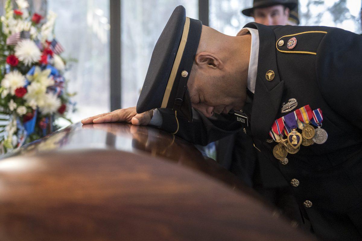 Sgt. Jose Burgos pauses for a moment at the casket of Vietnam veteran Peter Turnpu as hundreds of strangers gather for a funeral in Wrightstown, New Jersey, on Jan. 18, 2019. (Joe Lamberti/Camden Courier-Post via AP)