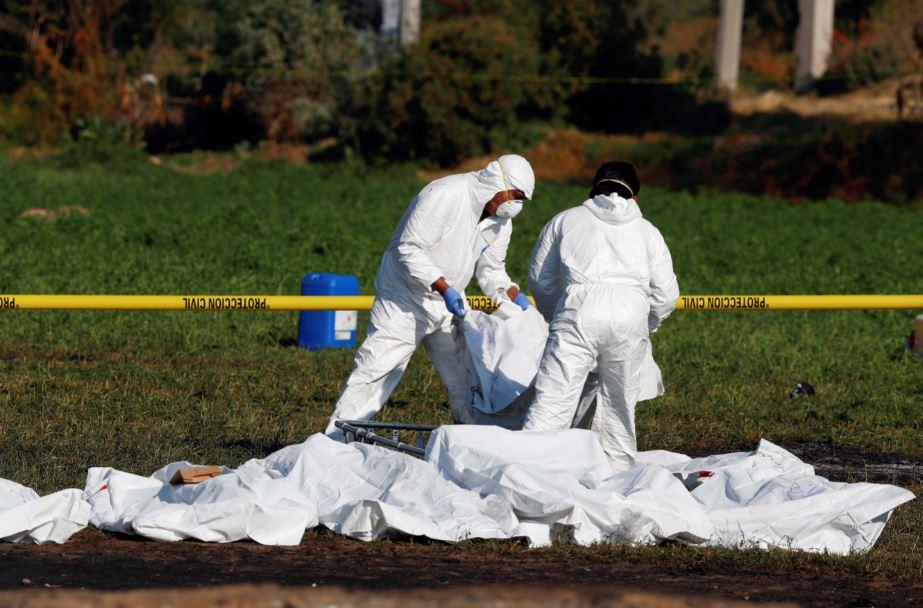 Forensic technicians arrange bodies at the site where a fuel pipeline exploded, in the municipality of Tlahuelilpan, state of Hidalgo, Mexico Jan. 19, 2019. (Henry Romero/Reuters)