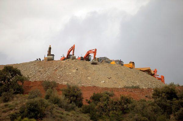 Idle diggers and trucks are seen after removing sand at the area where Julen, a Spanish two-year-old boy fell into a deep well six days ago when the family was taking a stroll through a private estate, in Totalan, southern Spain, on Jan. 19, 2019. (Jon Nazca/Reuters)