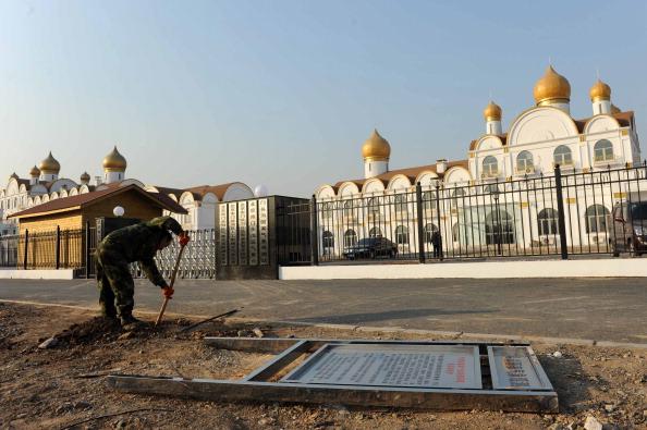 A man working outside an office complex resembling Moscow's Kremlin in the western Beijing suburb of Mentougou on Dec. 23, 2013. (STR/AFP/Getty Images)