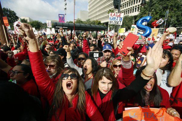 Educators rally as a strike against the Los Angeles Unified School District entered its fifth day outside City Hall in Los Angeles on, Jan. 18, 2019. (AP Photo/Damian Dovarganes)