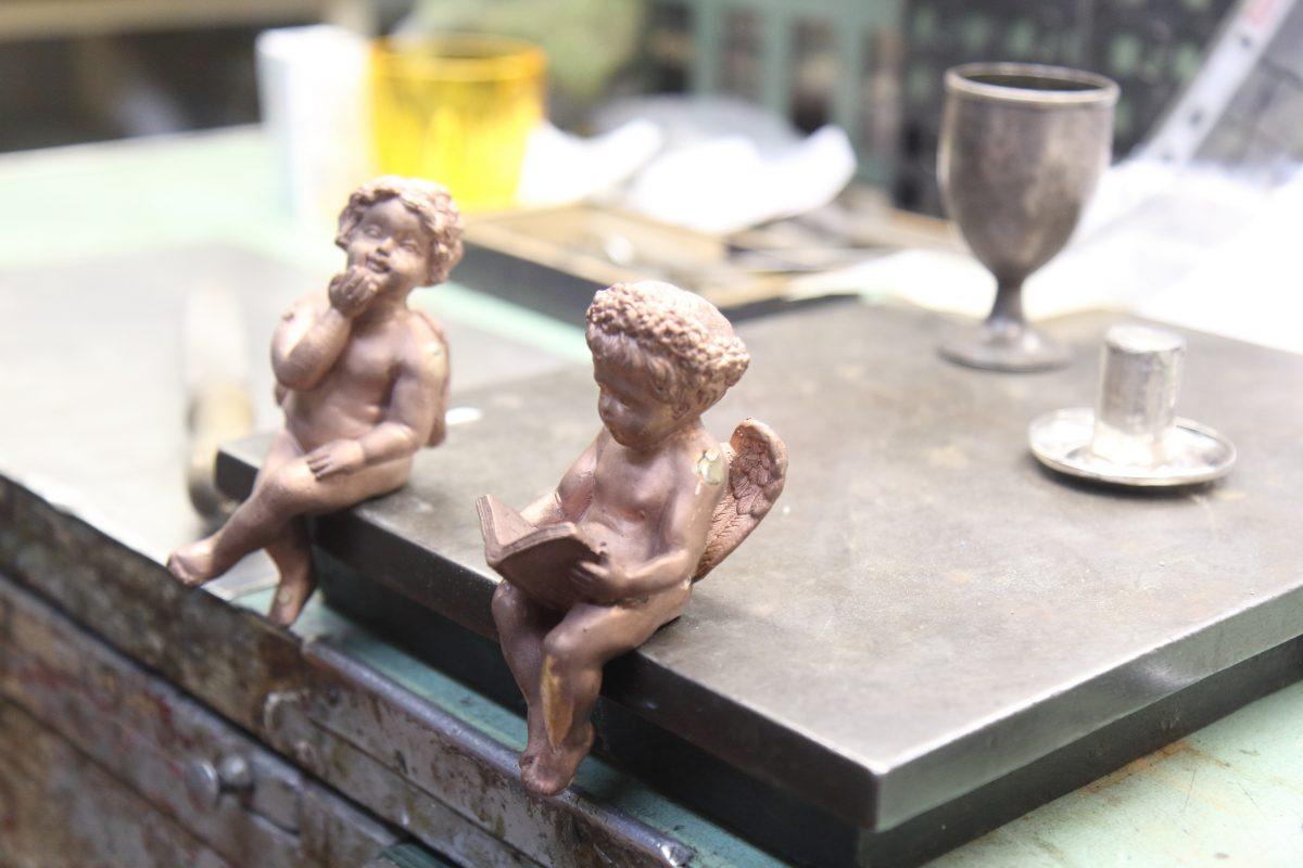 Two bronze cherubs, made by the traditional lost-wax process, wait to be refined. (Lorraine Ferrier/The Epoch Times)