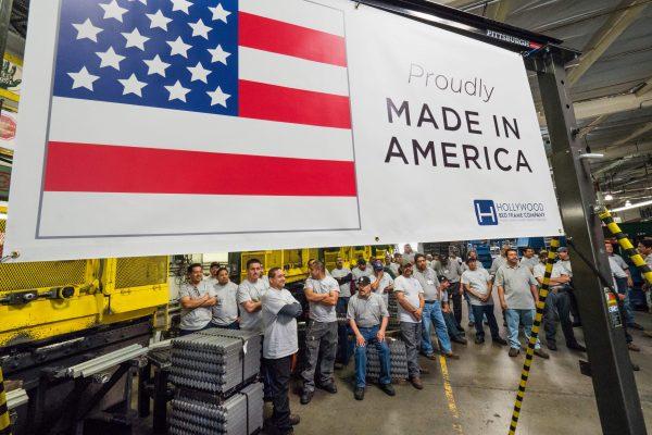 Workers at the Hollywood Bed Frame Company attend an event to mark the company's upcoming expansion which will double the manufacturer's workforce, adding 100 new local jobs, at the company's Commerce, Calif., factory seven miles southeast from downtown Los Angeles on April 14, 2017. (Robyn Beck/AFP/Getty Images)