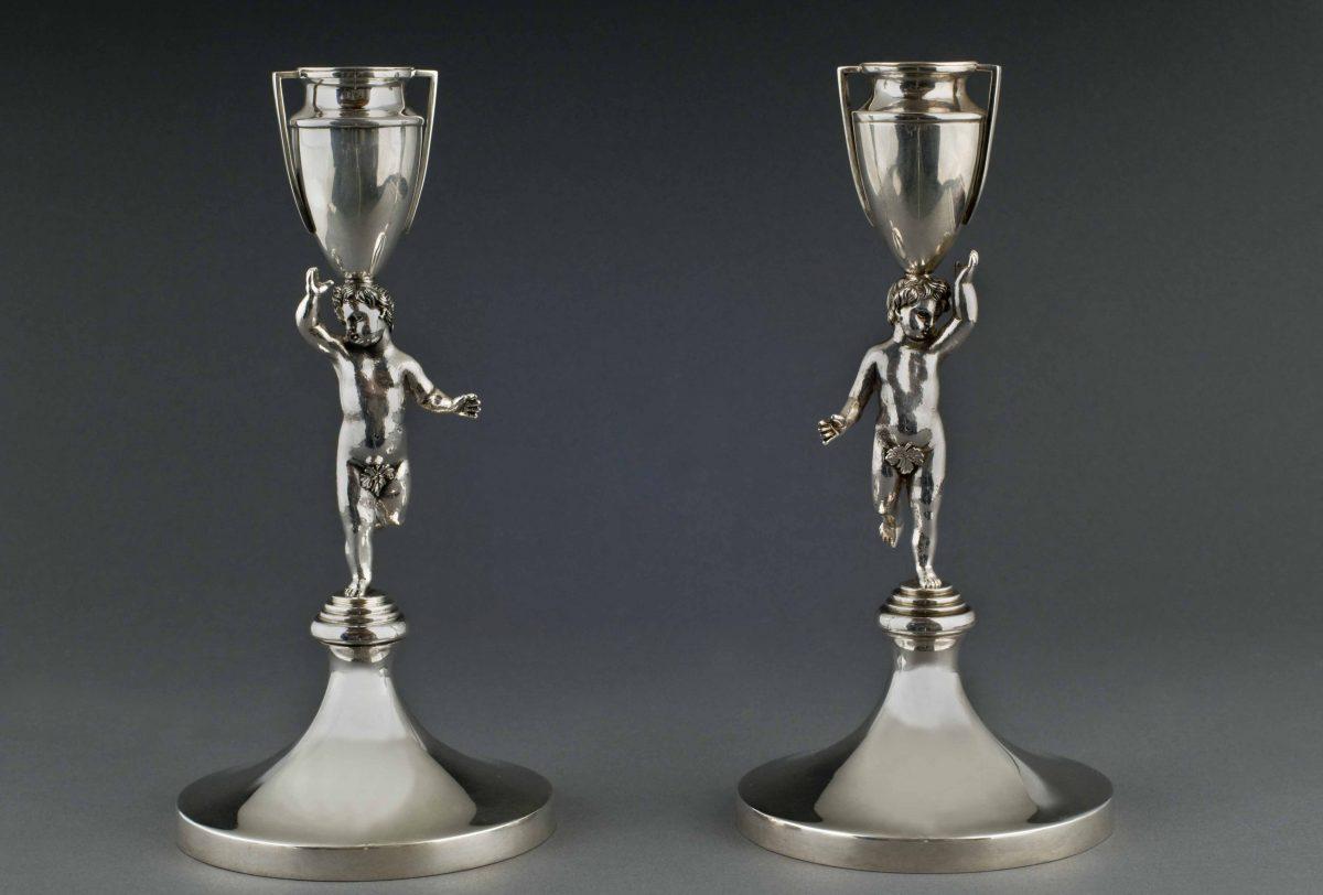 A pair of putti mirror each other in these sterling silver candlesticks, inspired by a Roman 19th-century neoclassical design, at the Silver Museum in Florence. (Lorenzo Michelini/Argentiere Pagliai)