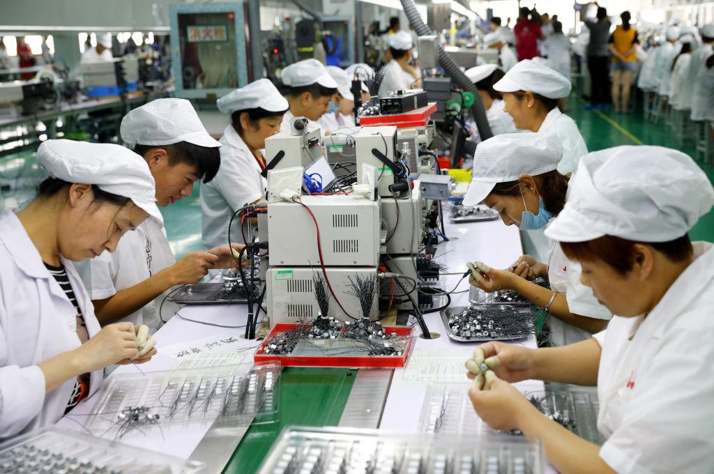 Employees work on a micro-motor production line at a factory in Huaibei City, Anhui Province, China on June 23, 2018. (AFP/Getty Images)