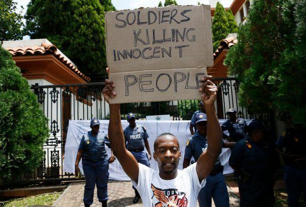A protester holds a placard during a demonstration of Zimbabwean citizens outside the Zimbabwean Embassy in Pretoria, South Africa, on Jan. 16, 2019. (Phill Magakoe/AFP/Getty Images)