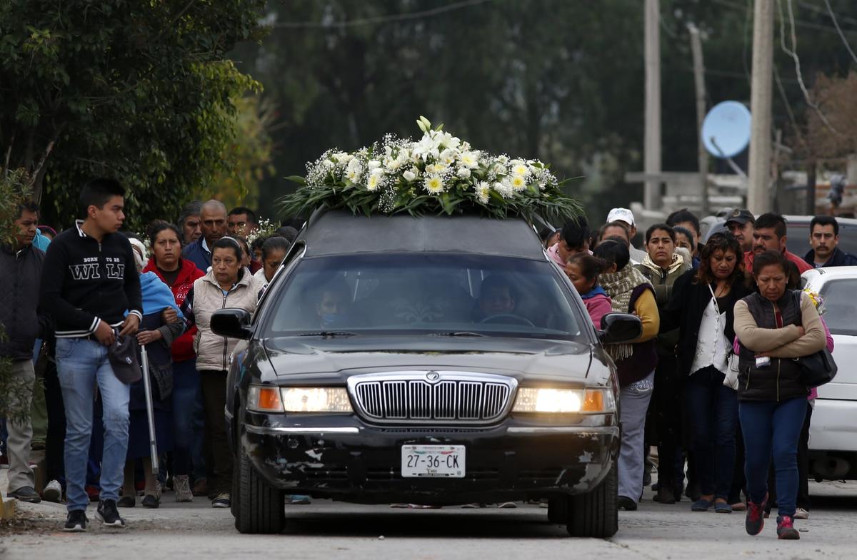 The relatives of Gerardo Preciado Cornejo, who died when a gas pipeline exploded, hold his funeral procession in the village of Tlahuelilpan, Mexico, Jan. 20, 2019. (AP Photo/Claudio Cruz)