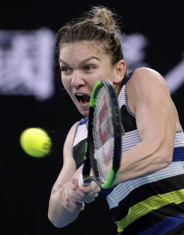 Romania's Simona Halep makes a backhand return to United States' Serena Williams during their fourth round match at the Australian Open tennis championships in Melbourne, Australia, on Jan. 21, 2019. (Kin Cheung/AP Photo)