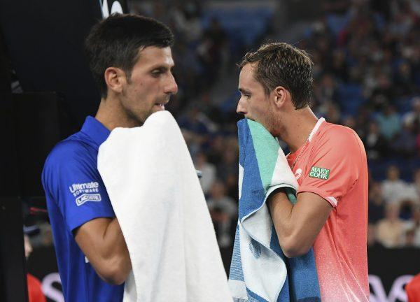 Serbia's Novak Djokovic, left, and Russia's Daniil Medvedev pass during a change of ends during their fourth round match at the Australian Open tennis championships in Melbourne, Australia, on Jan. 21, 2019. (Andy Brownbill/AP Photo/)