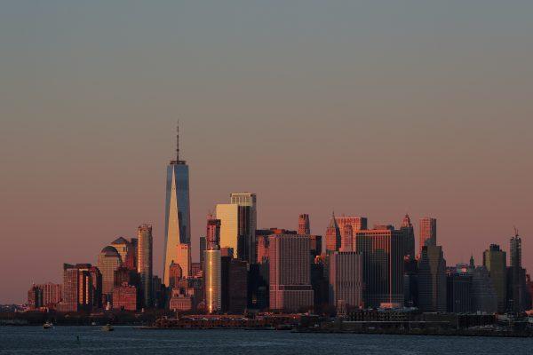 The setting sun is seen reflecting off 1 World Trade Center and other buildings in Manhattan in New York City, on Dec. 4, 2018. (Brendan McDermid/Reuters)