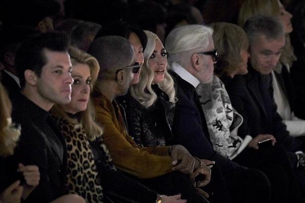 French actress Catherine Deneuve (2nd L), Stephen Gan (4th L), US singer and actress Lady Gaga (C), German fashion designer Karl Lagerfeld (3rd R) and French Luxury group Chairman and CEO Bernard Arnault (R) attend the Celine Spring-Summer 2019 Ready-to-Wear collection fashion show in Paris, on Sept. 28, 2018. (Anne-Christine Poujoulat/AFP/Getty Images)