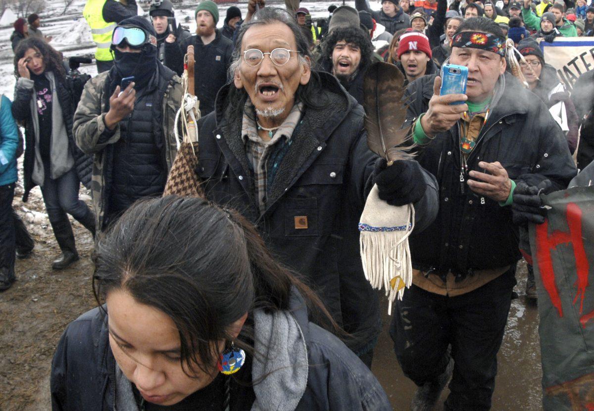 File—Nathan Phillips, (C with glasses) and other Dakota Access Pipeline protesters march in N.D. on Feb. 22, 2017. (Mike McCleary/The Bismarck Tribune via AP, File)